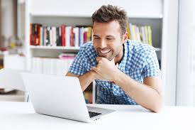 photo of a man using a laptop computer