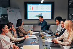 photo of a group of people around a table as if in a meeting