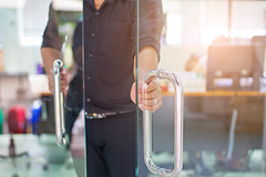 photo of a person opening an entryway door