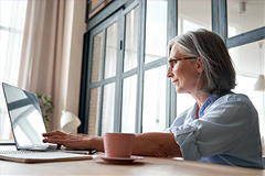 photo of an older woman at a computer