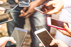 photo of several smartphones being held in people's hands